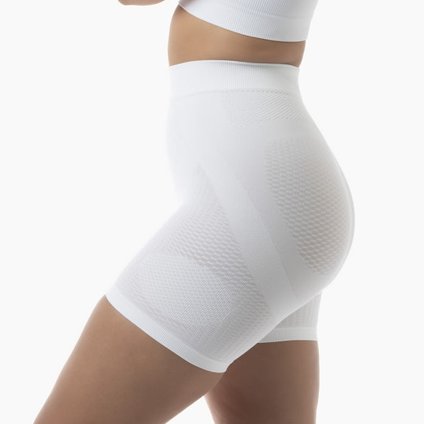 White compression shorts worn by a person on a white background