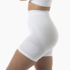 White compression shorts worn by a person on a white background