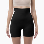 Black shapewear shorts worn by a person on a white background