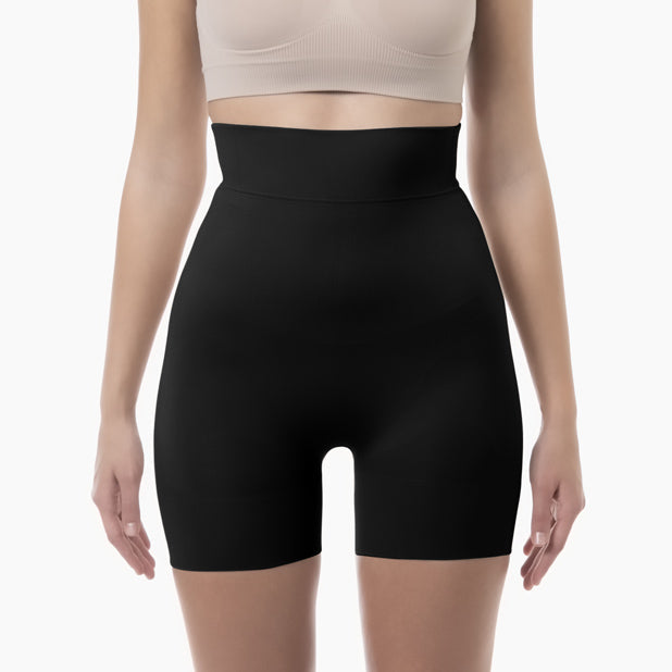 Black shapewear shorts worn by a person on a white background