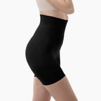 Black high-waisted shorts worn by a person on a white background