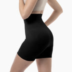 Person wearing black high-waisted shorts on a white background