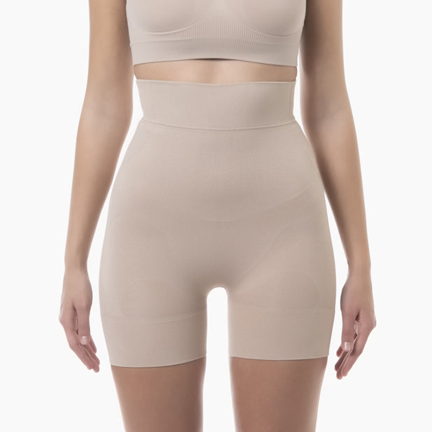Beige shapewear shorts worn by a model on a white background