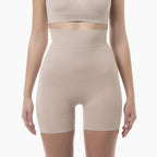 Beige shapewear shorts worn by a model on a white background