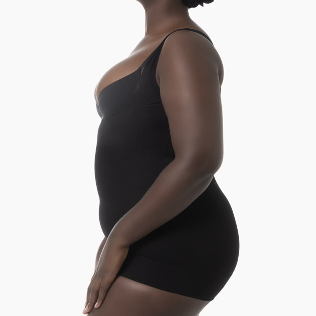 Black body shaper worn by a person on a white background