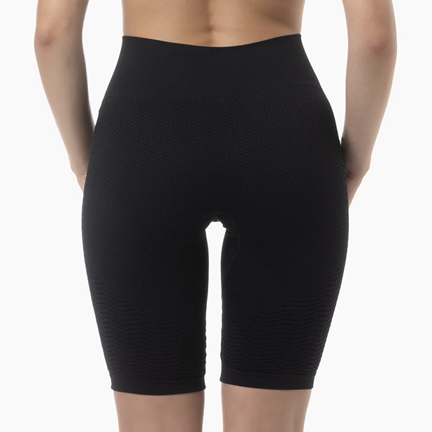 Black compression shorts worn by a person on a white background
