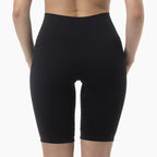 Black compression shorts worn by a person on a white background