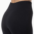 Black leggings with textured design on a white background