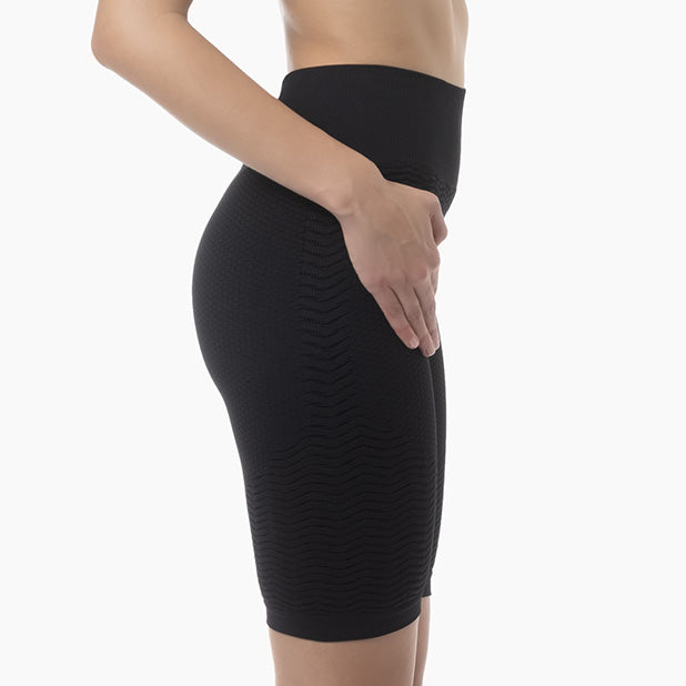 Black compression shorts worn by a person on a white background