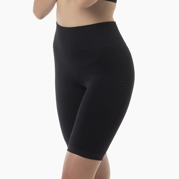 Black capri leggings worn by a person on a white background