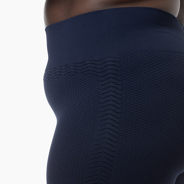 Navy blue compression garment with textured pattern on a white background