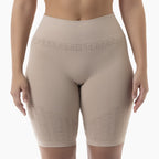 Beige compression shorts worn by a person on a white background