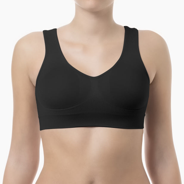 Black sports bra worn by a model on a white background