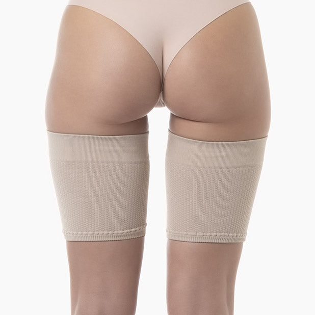 Beige shapewear being worn on a white background
