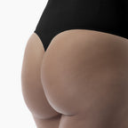 Close-up of a person wearing a black bodysuit on a white background