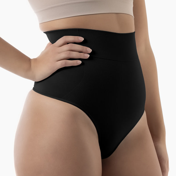 Black shapewear being worn by a person on a white background