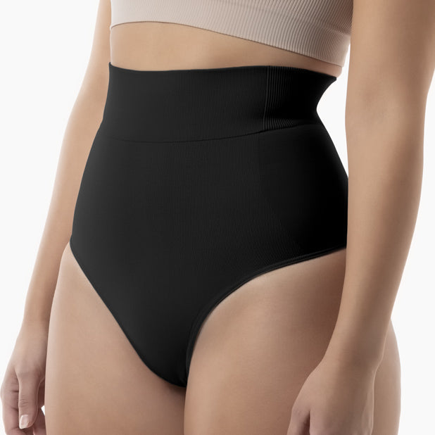Black high-waisted underwear worn by a person on a white background