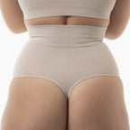 Beige shapewear being worn on a white background