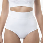 Person wearing white high-waisted underwear and a white crop top on a light background