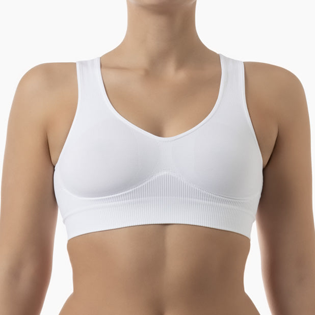 White sports bra worn by a person on a white background