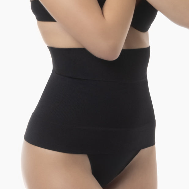 Black shapewear worn by a person on a white background