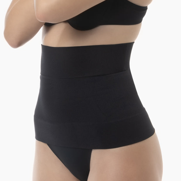 Black waist trainer worn by a person on a white background