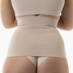 Beige shapewear garment worn by a person on a white background