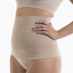 Beige compression garment worn by a person on a white background
