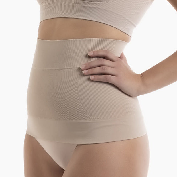 Beige compression garment worn by a person on a white background