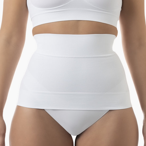 White shapewear garment worn by a person on a white background
