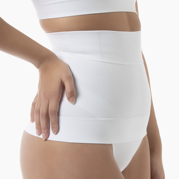 White shapewear garment worn by a person on a white background